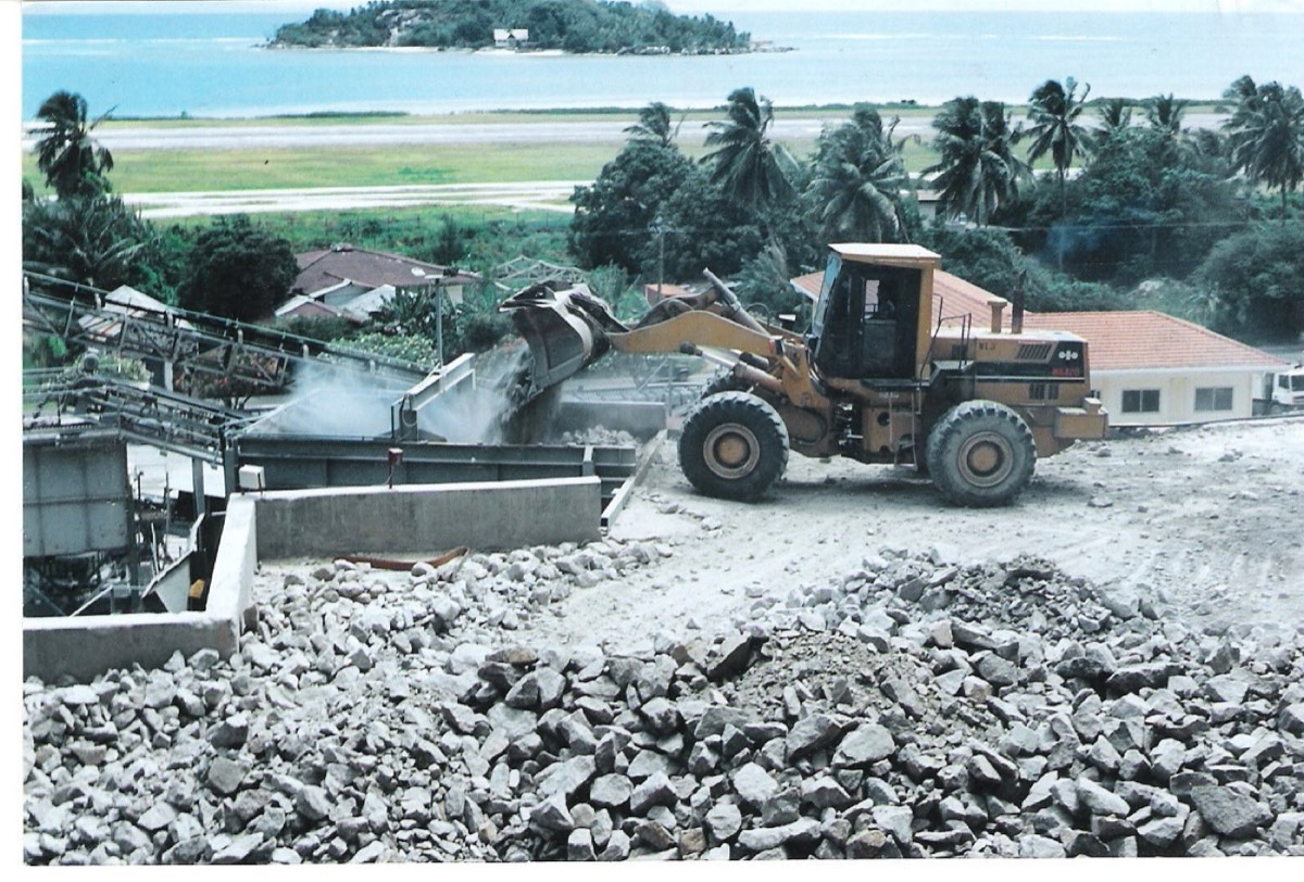 Dry fog system installed on a ROM tip with front-end loader feeding the crusher